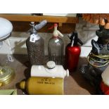 Three Vintage Soda Syphons, Together With Two Stoneware Foot Warmers