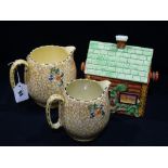 A Price Bros Cottage Biscuit Box, Together With Two Royal Winton Chintzware Jugs