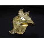 A Cast Brass Plaque Of A Winged Helmet