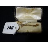 A Fifteen Ct Gold Shepherds Crook Brooch & Safety Chain