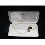 A String Of Kimura Cultured Pearls With 9ct Gold Clasp