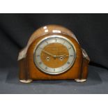 A Polished Oak Encased Mantel Clock With Circular Dial