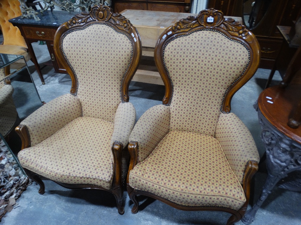 A Pair Of Reproduction Spoon Back Elbow Chairs
