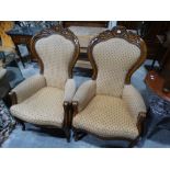 A Pair Of Reproduction Spoon Back Elbow Chairs