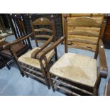 A Pair Of Rush Seated Oak Ladder Backed Carver Chairs