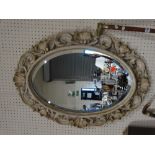 A Cream Framed Oval Wall Mirror