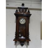 A Victorian Pendulum Wall Clock With Circular Dial