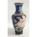CHINESE CLOISONNE VASE with a blue ground decorated with flowers, 25.5cm high, with a circular
