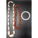 IVORY BEAD NECKLACE with graduated lozenge shaped beads, a white jadeite bangle and a graduated