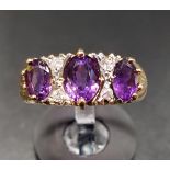 AMETHYST AND DIAMOND RING the three graduated oval cut amethysts separated by small diamonds, on