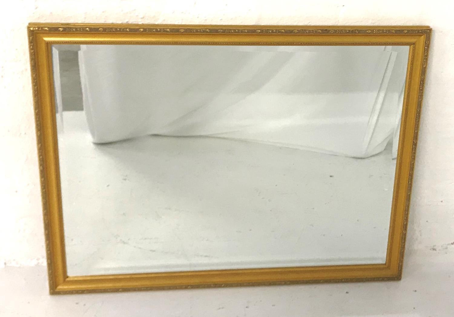 GILT FRAMED WALL MIRROR with a rectangular bevelled plate, 111cm x 85.5cm