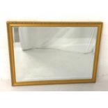 GILT FRAMED WALL MIRROR with a rectangular bevelled plate, 111cm x 85.5cm