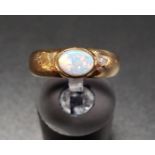 OPAL SINGLE STONE RING the bezel set opal on nine carat gold shank, ring size L-M