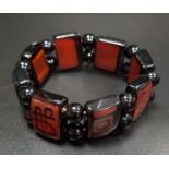 AGATE AND ONYX BRACELET the eight rectangular panels with linear decoration and separated by
