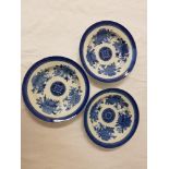 THREE CHINESE BLUE AND WHITE BOWLS decorated with floral segments around a central medallion, 24.5cm