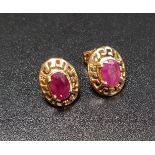 PAIR OF RUBY STUD EARRINGS the oval cut rubies in pierced unmarked gold mounts, with ten carat