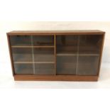 TEAK CABINET with a rectangular top above two pairs of glass sliding doors with a shelved