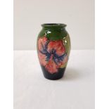 MOORCROFT HIBISCUS PATTERN VASE of ovoid form with a green ground and impressed mark to base, 10.5cm