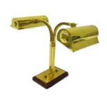 DOUBLE BRASS DESK LAMP raised on a rectangular base with two shaped columns and two adjustable