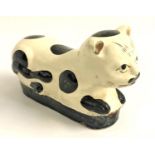 CHINESE CI ZHOU WARE POTTERY CAT lying recumbent with a cream coloured body with brown markings,