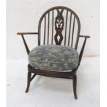ERCOL STICKBACK ARMCHAIR with a shaped back with a central splat above a pair of shaped arms with