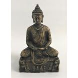 BRASS BUDDHA seated with crossed legs on a plinth supported by mythical beasts, 20cm high