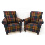 PAIR OF EARLY 20TH CENTURY ARMCHAIRS covered in plaid and each with a loose cushion, standing on