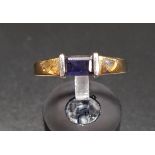 IOLITE SINGLE STONE RING the emerald cut gemstone flanked by white gold linear mounts, on nine carat