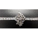 IMPRESSIVE DIAMOND BRACELET the central diamond cluster formed of round, baguette and marquise