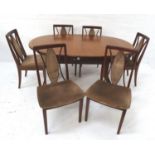 G PLAN MAHOGANY DINING TABLE with an oval pull apart top revealing a fold out leaf, standing on