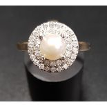 PEARL AND DIAMOND CLUSTER RING the central pearl in double diamond surround totalling