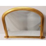SHAPED OVERMANTLE MIRROR in a giltwood frame, 72cm x 102cm