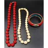 IVORY BEAD NECKLACE with eleven decorative carved beads and twenty two plain circular beads, a