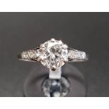 IMPRESSIVE DIAMOND SOLITAIRE RING the central round cut diamond approximately 1.1cts, flanked by