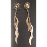 PAIR OF TWO TONE NINE CARAT GOLD DROP EARRINGS each earring with three wavy drops