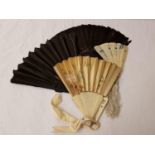 LADIES CONTINENTAL FEATHER FAN with ebonised sticks, an Italian tourist fan, the leaves covered in