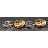 FOUR SILVER RINGS two CZ set gilt crossover examples and two with interlocking design (4)