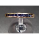 CHANNEL SET SAPPHIRE HALF ETERNITY RING in ten carat gold, ring size N