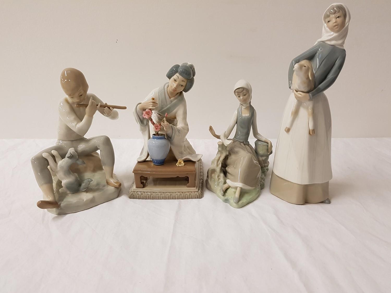 THREE LLADRO FIGURINES comprising a young girl holding a lamb, 27.5cm high, a seated young girl with