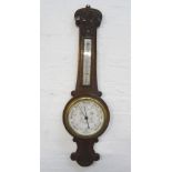 ADMIRAL FITZROY'S ANEROID BAROMETER in a carved oak case with a thermometer above a circular dial,