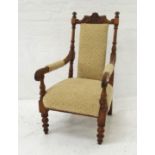 EDWARDIAN WALNUT ARMCHAIR with a shaped and carved top rail above a central padded back, with part