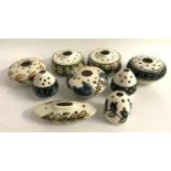 NINE JERSEY POTTERY POSY BOWLS AND FLOWER HOLDERS of various shapes and with a variety of floral and