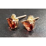 PAIR OF GARNET STUD EARRINGS the garnets in unmarked gold mounts with fourteen carat gold