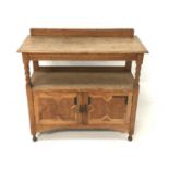 OAK BUFFET with a moulded top and raised back supported by columns above a lower shelf with two