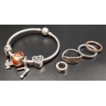 SELECTION OF SILVER PANDORA JEWELLERY comprising a Moments silver bangle with five charms, three