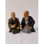 TWO JAPANESE URASAKI DOLLS PORCELAIN FIGURINES depicting two kneeling men in traditional dress,