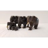 SET OF SIX CARVED EBONY ELEPHANTS of graduated size with ivory detail (6)