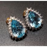 PAIR OF BLUE TOPAZ AND DIAMOND EARRINGS the pear cut blue topaz on each within illusion setting with