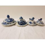 FOUR CHINESE PORCELAIN LIDS each of circular form, two with dog finials and two with shaped finials,
