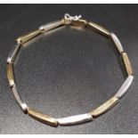 NINE CARAT TWO TONE GOLD BRACELET with alternating white and yellow gold links, 19.2cm long and